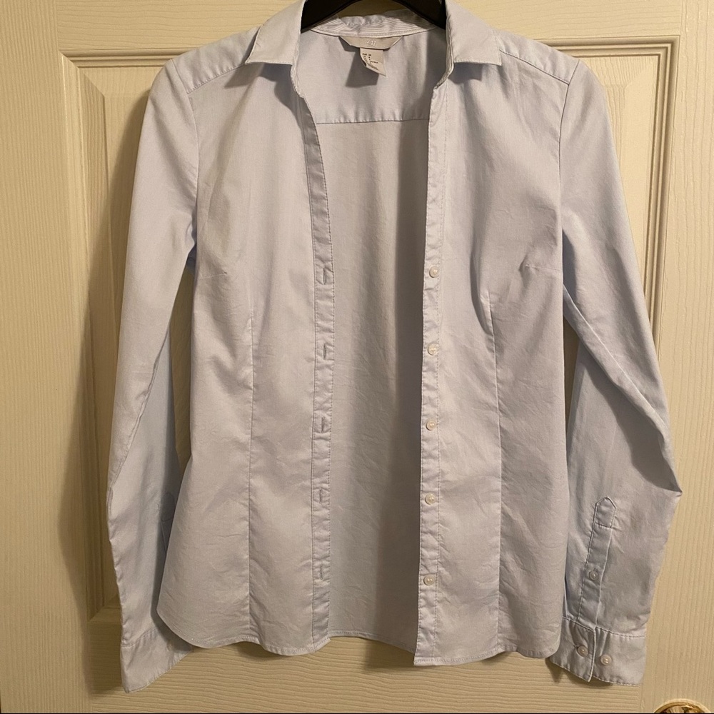 Light blue long sleeve button up tailored shirt. Size 4.  Brand is H&M.